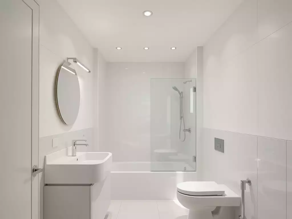 Modern small bathroom with light colors, clean design, and strategic lighting